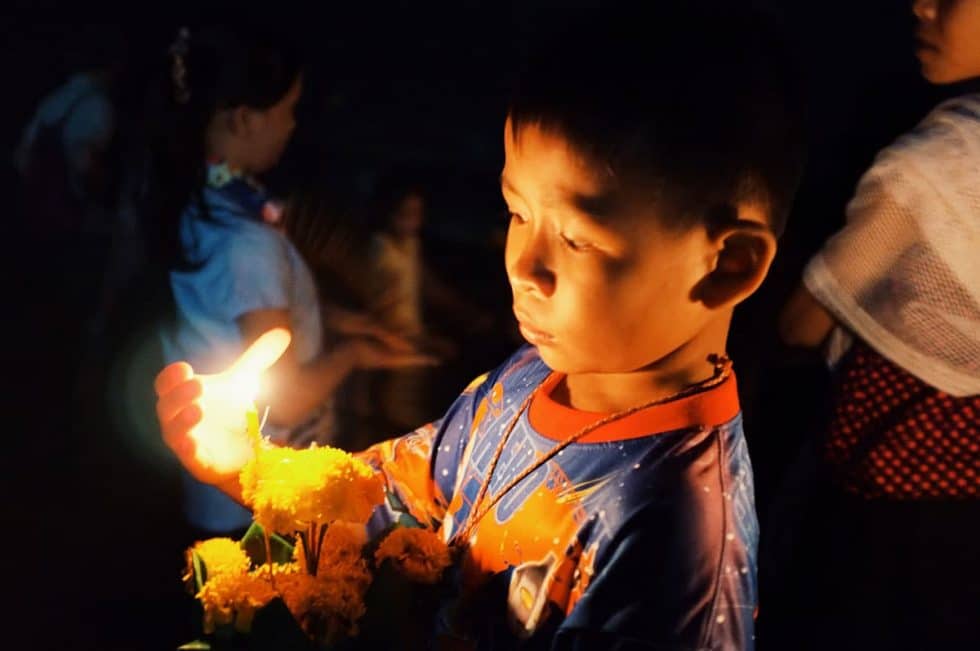 Buddhist child at a ceremony in Si Phan Don (4000 Islands), Laos | Happymind Travels