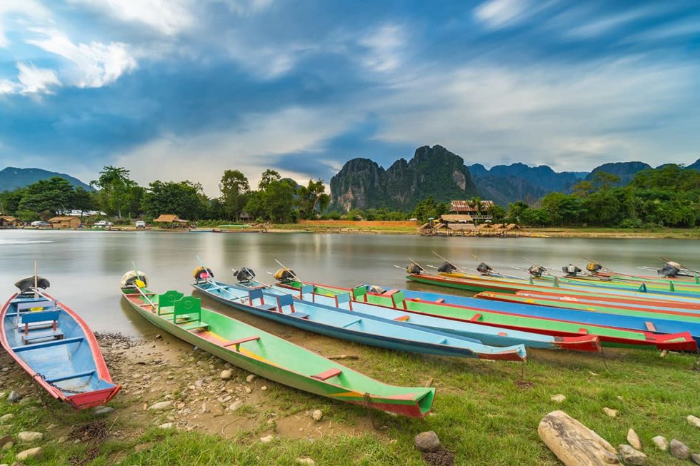 Long Kayak Boats on the Naw Song River in Vang Vieng, Laos | Happymind Travels