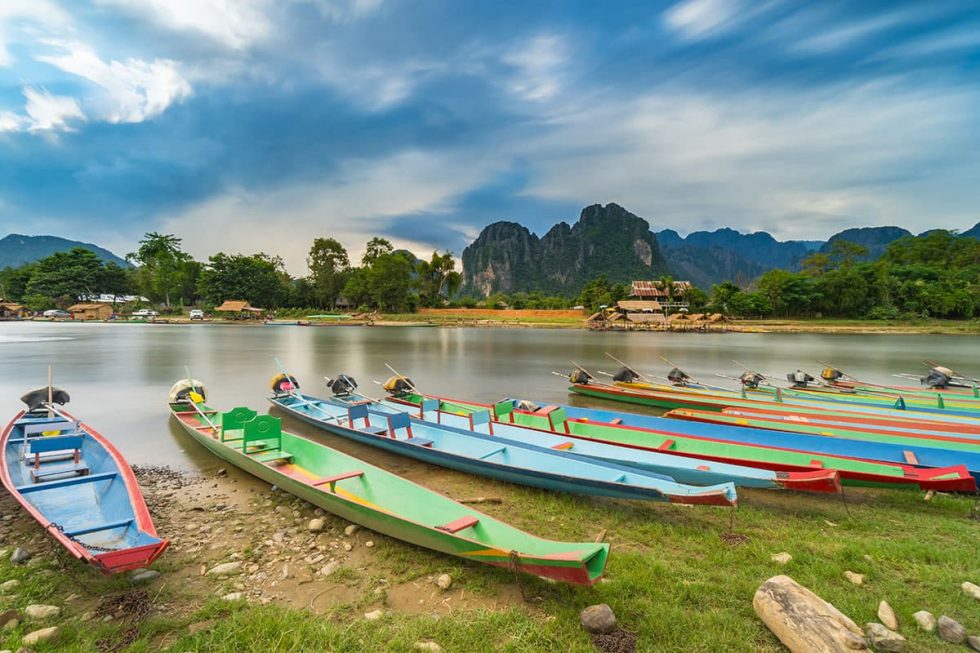 Long Kayak Boats on the Naw Song River in Vang Vieng, Laos | Happymind Travels